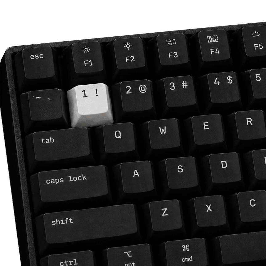 Close-up of Code One’s keycaps: Space Mono legends on black PBT, with the one white key
